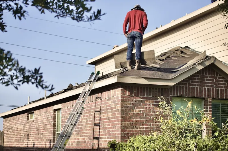 Professional roofer working on a residential roof in Cedar Beach